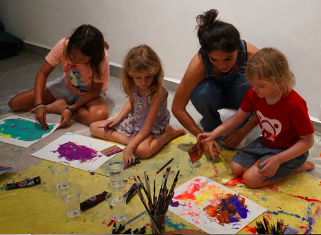 Young students painting during a workshop facilitated by Anya Minko